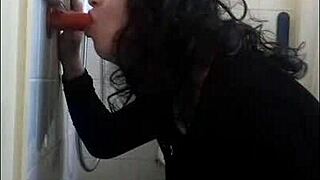 Skinny poofter wearing daisy dukes with a large uncut cock and small knockers suck a dildo while a fellow bareback bottoms her