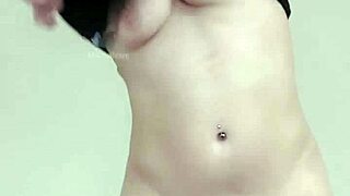 Blonde milf stripteaser strips nude revealing shaved piercing and asshole.