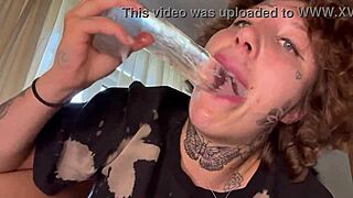This tatted girl gives a rough blowjob using a dildo until she cries