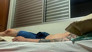 Soloboy amateur strokes himself with intense focus. His tattooed body shines during solo play.