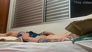 Soloboy amateur strokes himself with intense focus. His tattooed body shines during solo play.