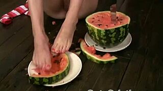 Cute Cristina strips naked and teases with watermelon on her feet intensely.