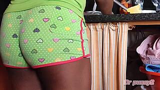 Secret camera captures ebony woman in domestic tasks. Teasing hidden desires unfold.