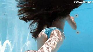 Hot Hungarian teen Lana swims nude in the pool, showing her juicy ass underwater.