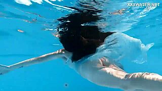 Hot Hungarian teen Lana swims nude in the pool, showing her juicy ass underwater.