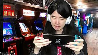 Chinese gamer girl Alexandria Wu shows off her assets as she plays out side