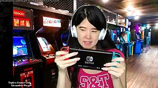 Chinese gamer girl Alexandria Wu shows off her assets as she plays out side