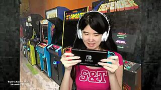 Chinese gamer girl Alexandria Wu shows off her assets as she plays out side