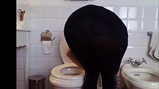 A sexy babe in a miniskirt smokes in a private setting.