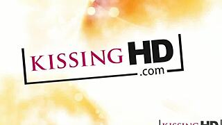 A perfect young girl with puffy features shares a tender kiss with her lesbian girlfriend.