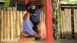 A man approaches a naked girl outdoors