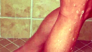 Small brunette beauty enjoys a hot shower