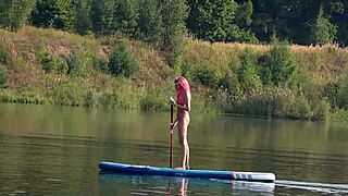 Skinny babe flashes pink micro bikini outdoors