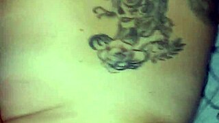 Watch this tattooed latina scream as she takes a facial cumshot on her big tits in thong.