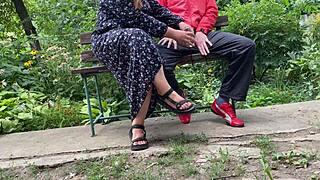 Milf jerks big dick into glass on park bench