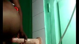 black girl sets up dildo on wall for acrobatic fun