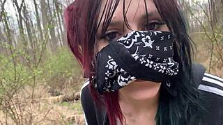 Emo girl enjoys a walk in the public park.