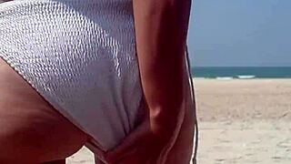 Peeing in White Bikini on Public Beach with Fat Ass