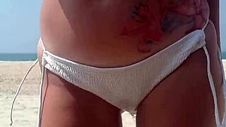 Peeing in White Bikini on Public Beach with Fat Ass