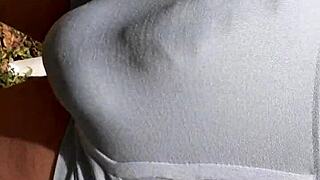 public hardon strains tight shorts in outdoor setting