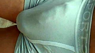 public hardon strains tight shorts in outdoor setting