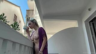 Blonde beauty exposes herself naked on the balcony