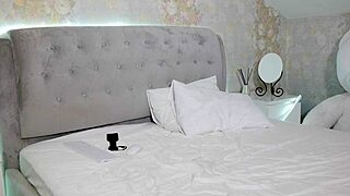 Student with big tits undresses after studying, teasing the camera.