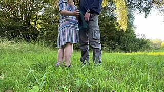 the sexy milf removes her panties outdoors in nature to give a handjob while showing her hairy beaver and big ass