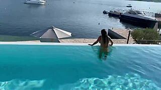 Gorgeous monika fox strips for naked swim in outdoor pool. Pierced nipples shine on big fake tits in public.